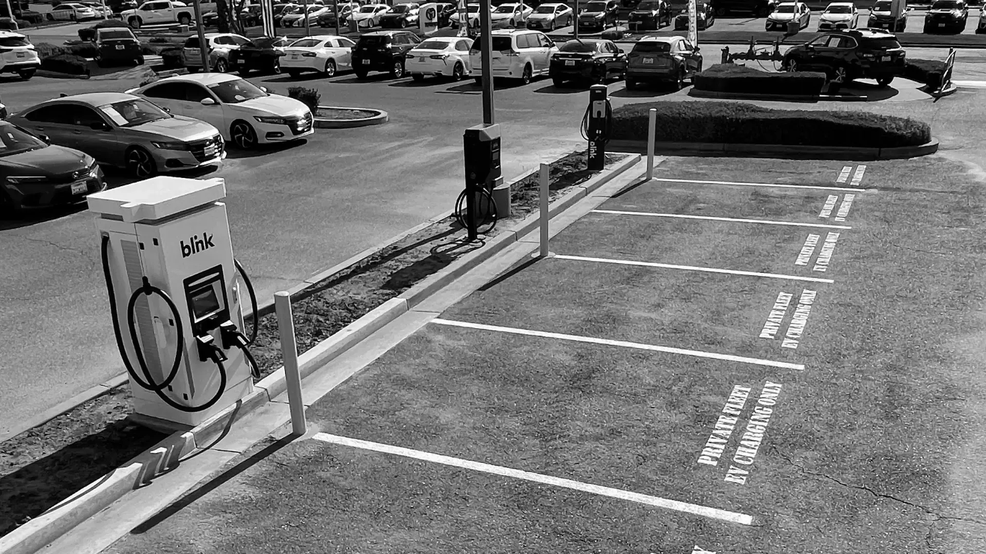 Electric vehicle charging stations in a parking lot with marked charging-only spaces