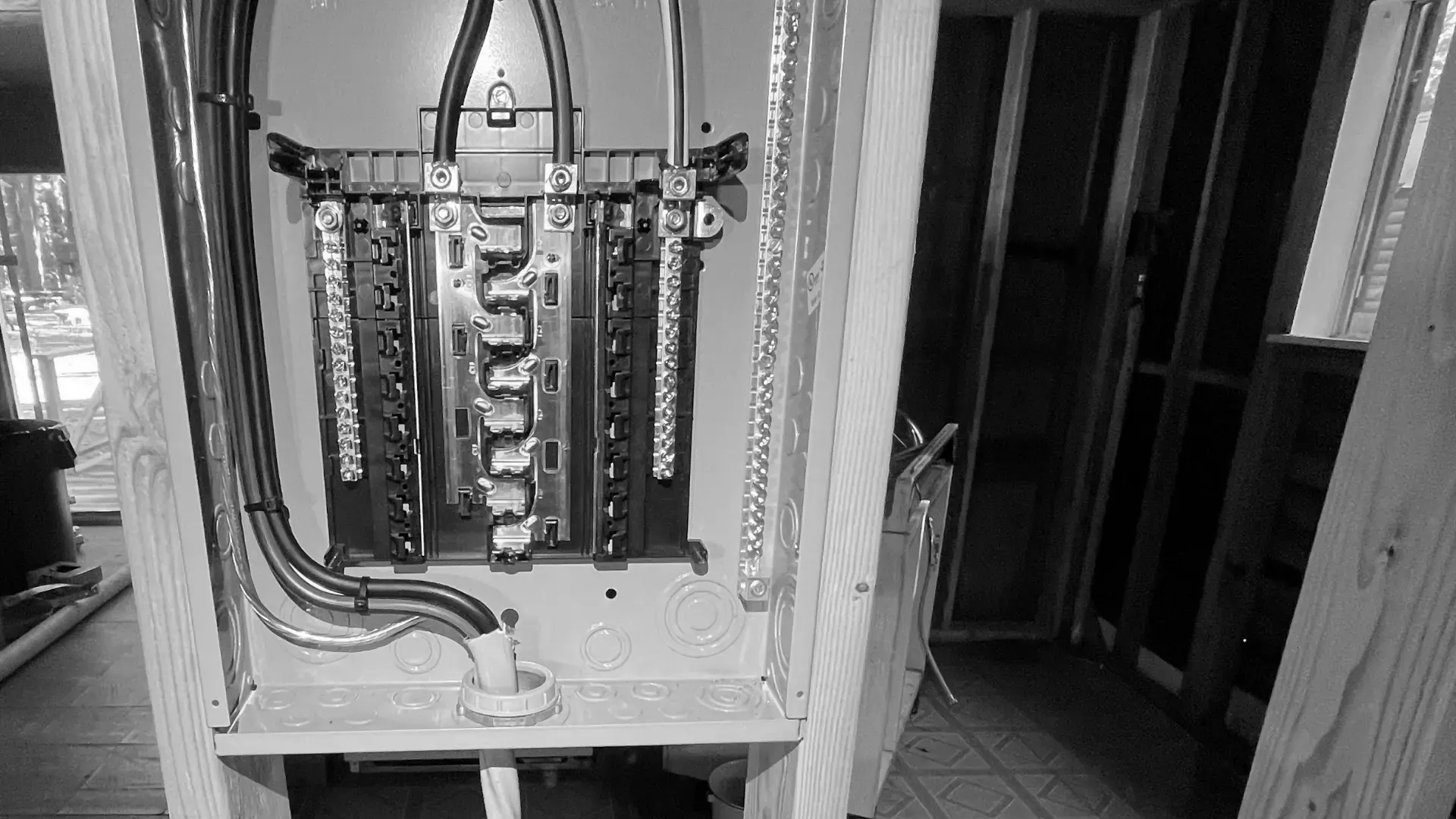 New breaker panel wired into the framing of a building under construction